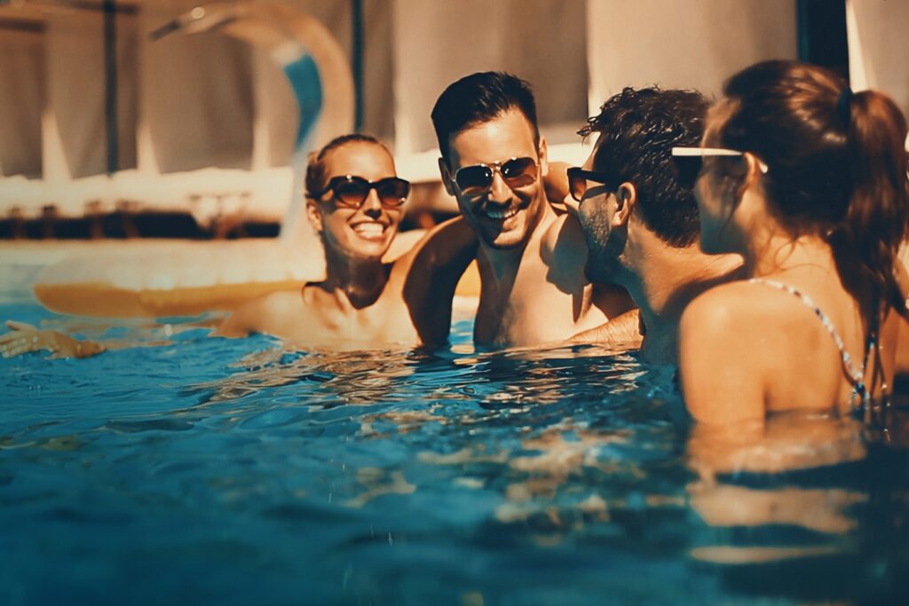 people enjoying drinks by the swimming pool.